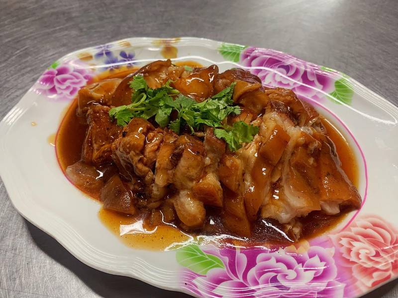 หมูตุ๋นราดน้ำเกรวี่สีน้ำตาลบนจานลายดอก
